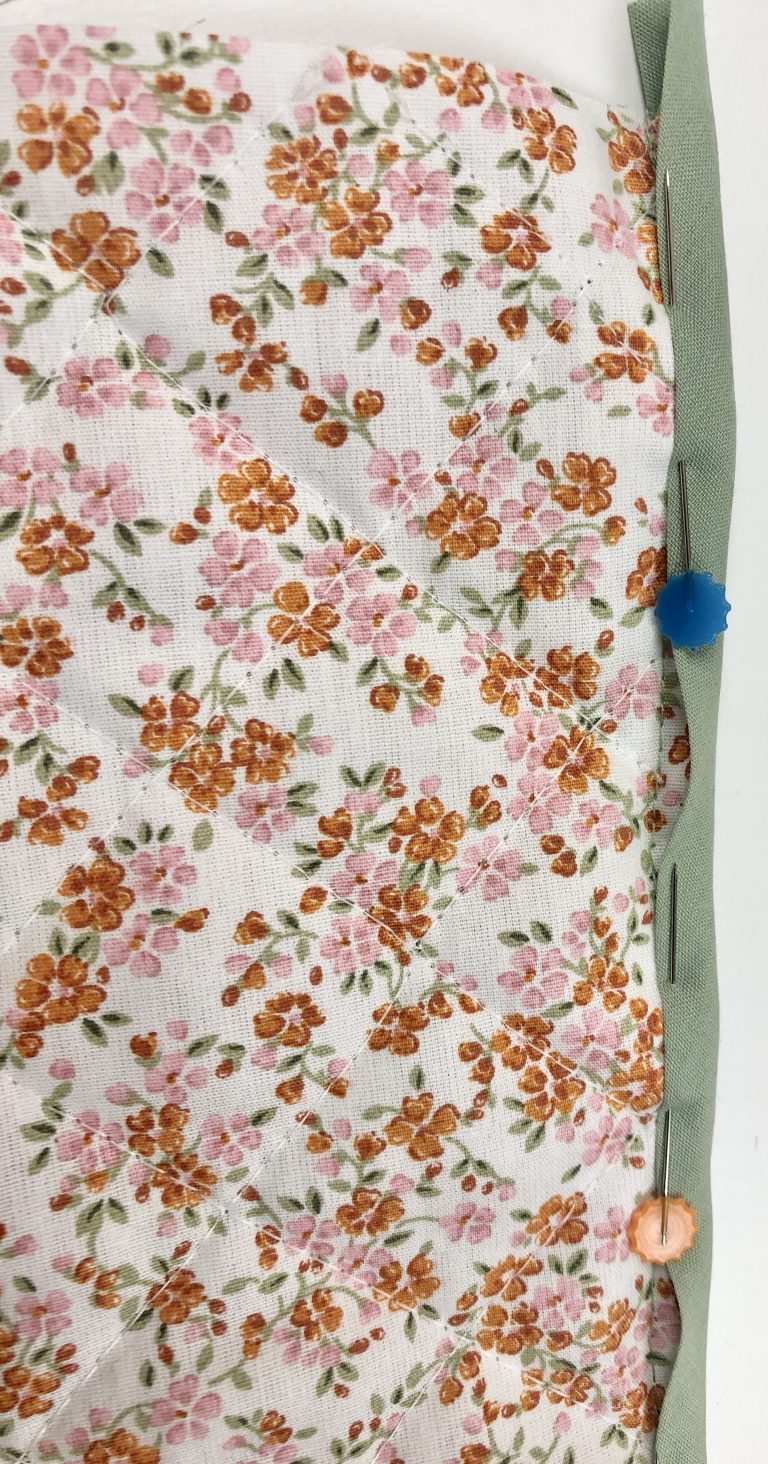 bias binding pinned in place to floral fabrics