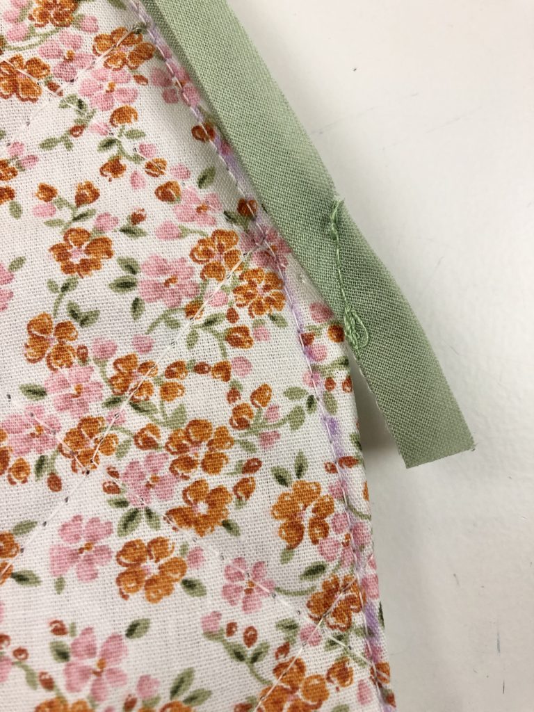 binding attached to floral quilted fabric