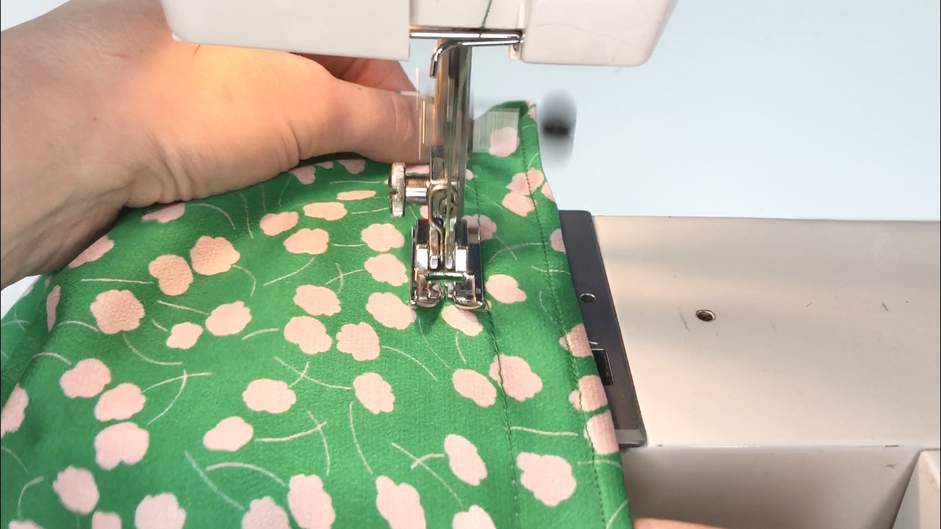 stitching in a spiral on green fabric