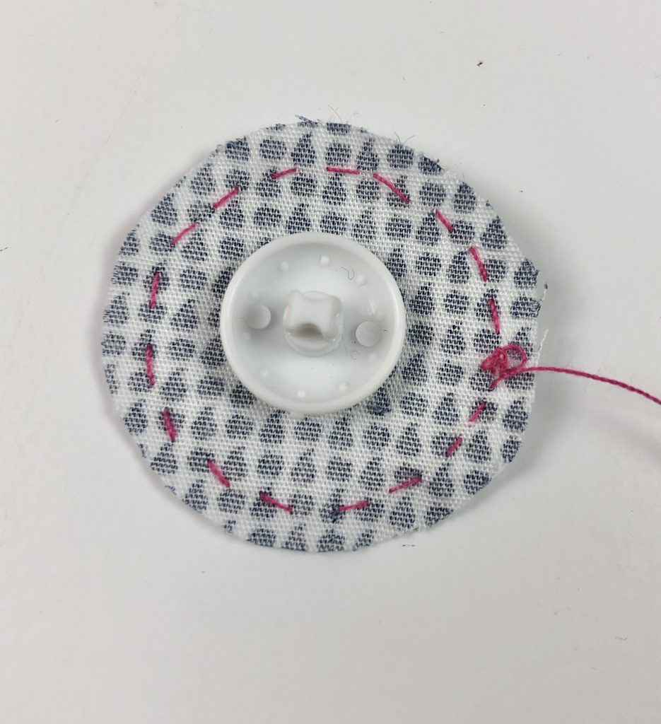 button placed in middle of fabric circle