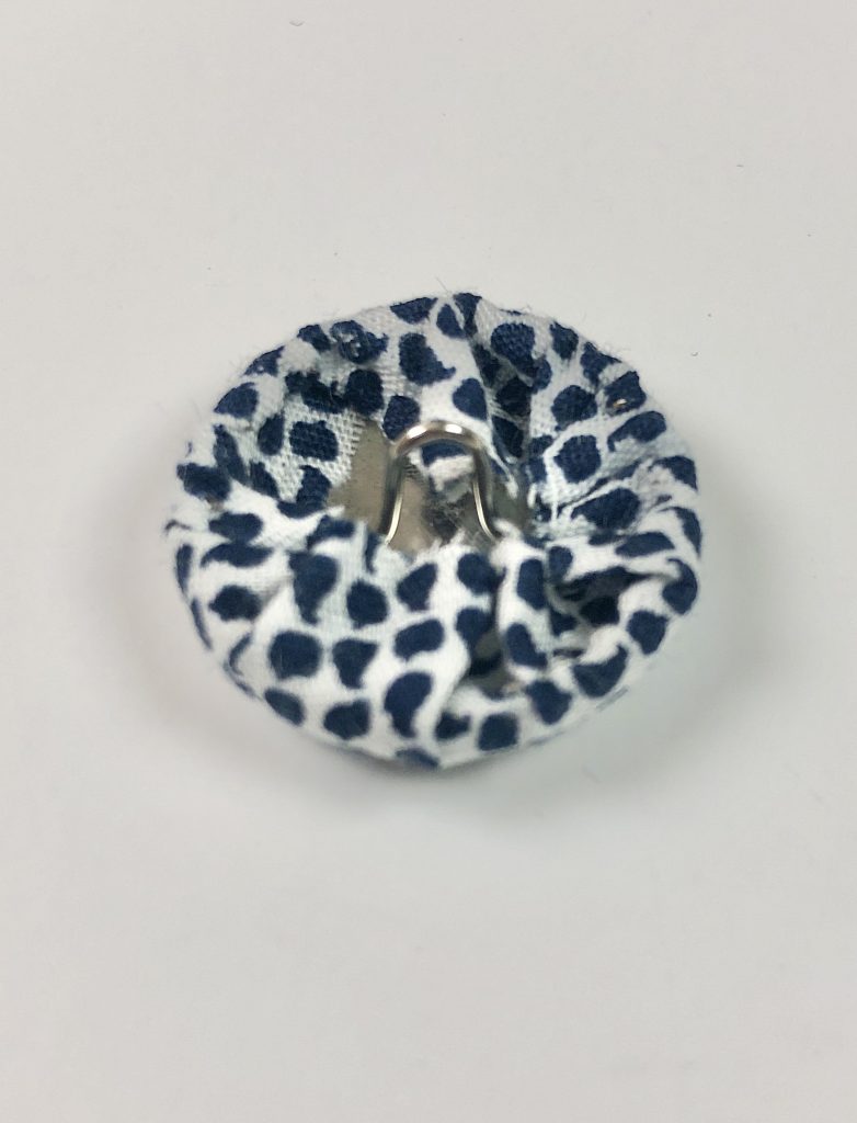 metal button wrapped with fabric