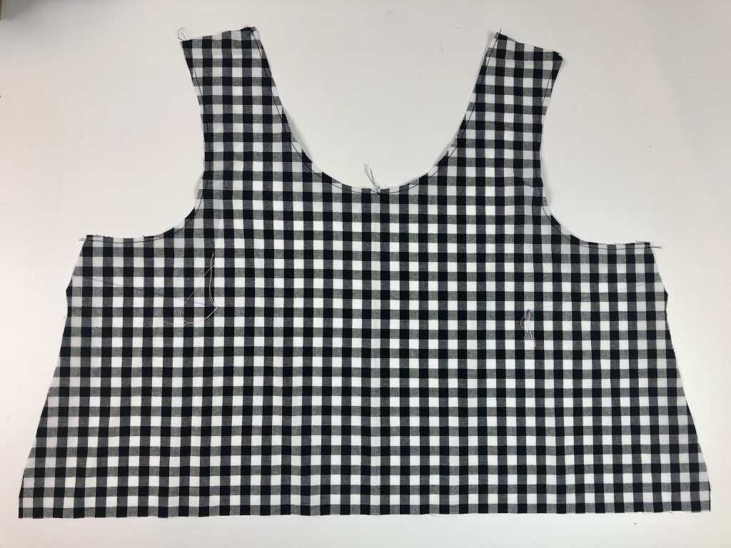 black gingham with stay stitching shown around neckline and armhole