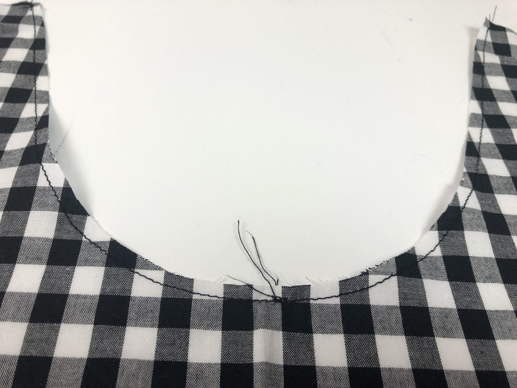 black gingham fabric with stitching line around curved edge