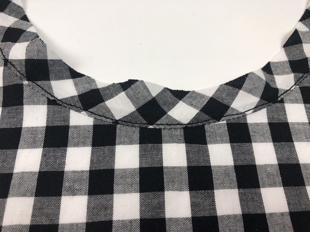 black gingham fabric with finished understitching on binding