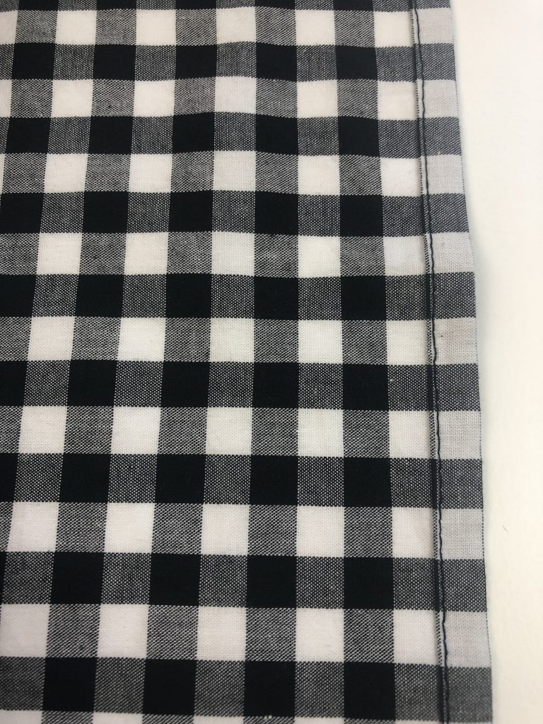 black gingham fabric with stitching line