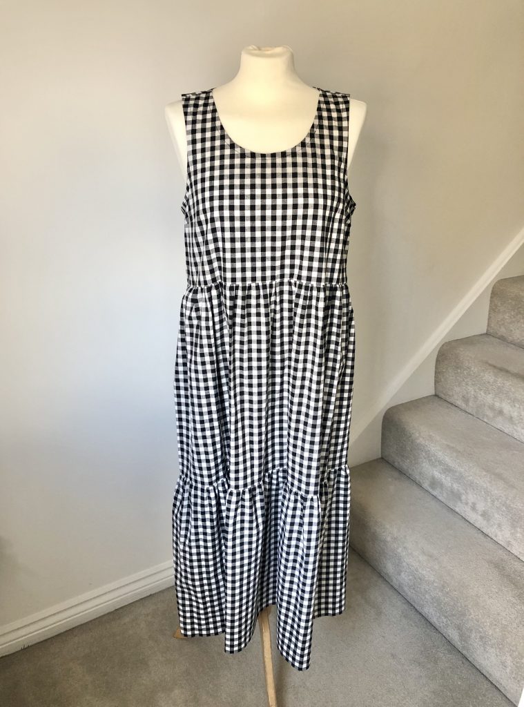 the Verano dress - a black and white gingham dress on a white mannequin