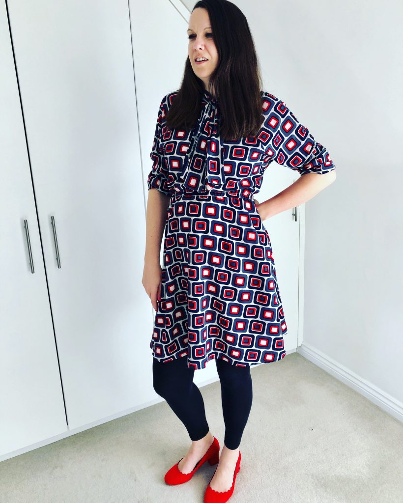 Julia in the Stella shirt dress with red heels and black leggings