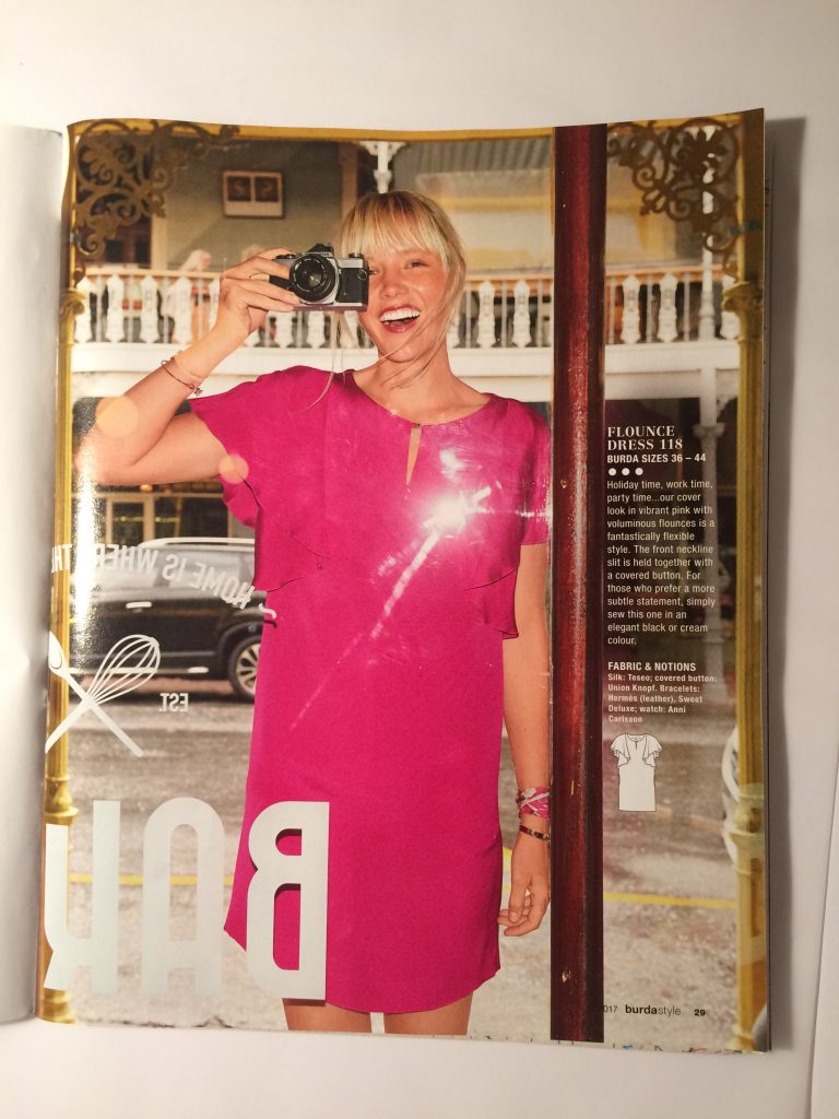 pink / purple dress on blond white woman in a magazine