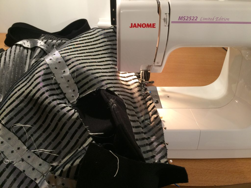 image of Janome sewing machine and coat sewing in progress