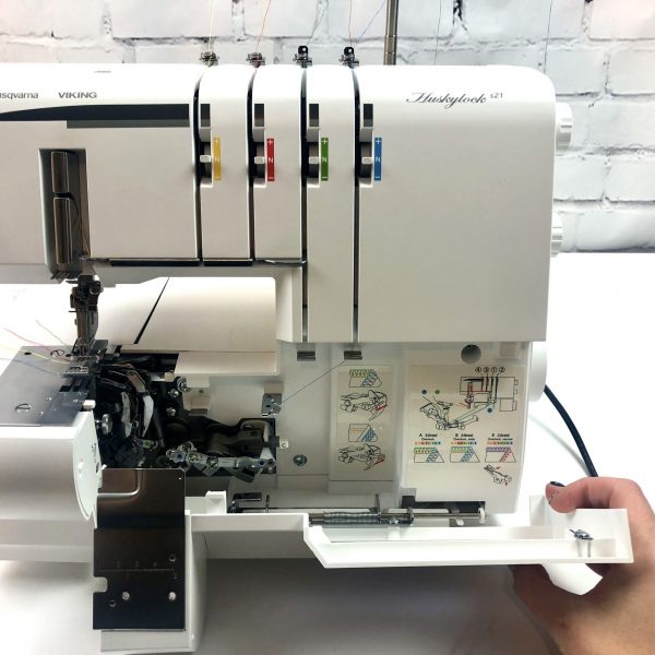 coverstitch machine with looper cover partly open